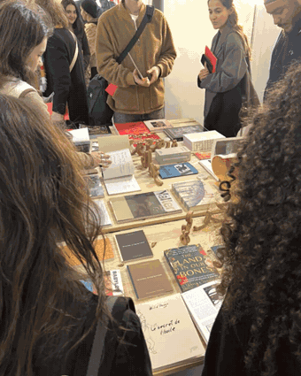 Storm books and people, Paris pop-up — bookstore table, portrait, and publications
